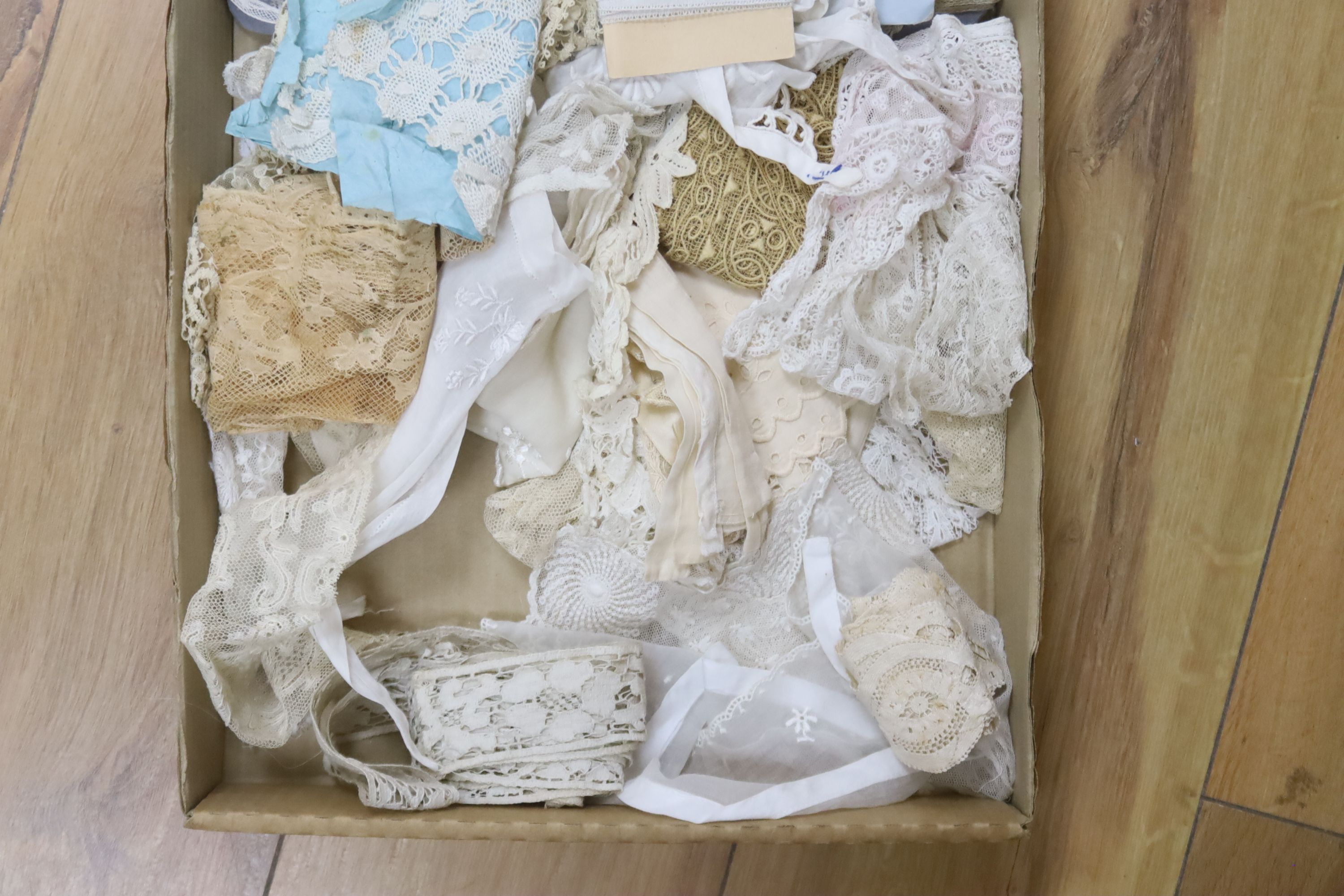 A box of mixed hand made and machine made lace trimmings